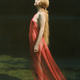 Portrait of a nude woman draped with red silk.